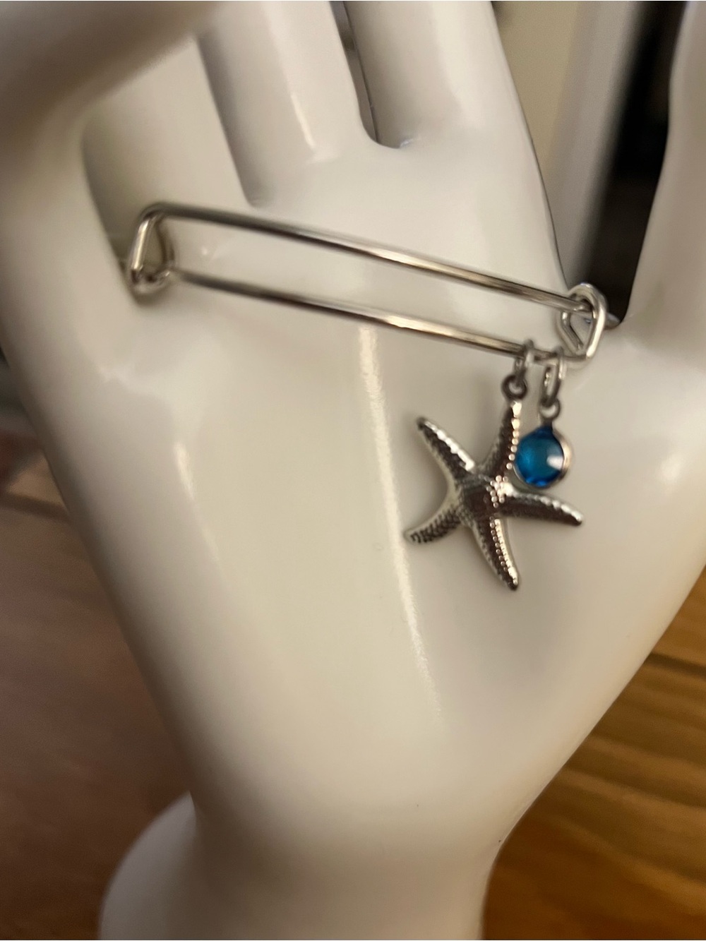 Silver Starfish Bangle Bracelet with Blue Charm